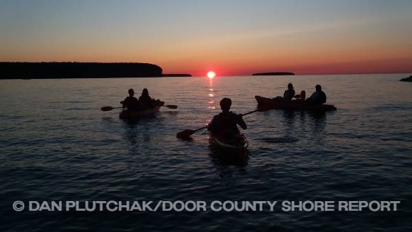 A kayak tour watches the sun set, Sister Bay. Commercial, stock and fine-art photography by Dan Plutchak/Door County Shore Report.